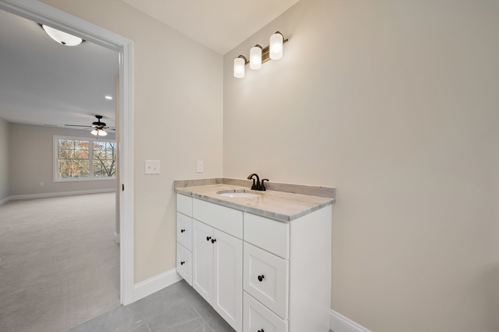 53 Kimball Hill Road, Unit A Hudson, NH 03051 - Photo 22 of 41 a bathroom with a granite countertop sink and a mirror