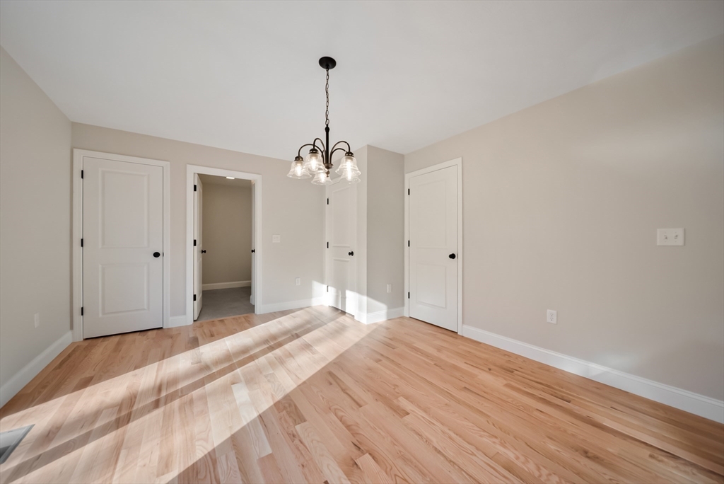53 Kimball Hill Road, Unit A Hudson, NH 03051 - Photo 27 of 41 a view of empty room with wooden floor