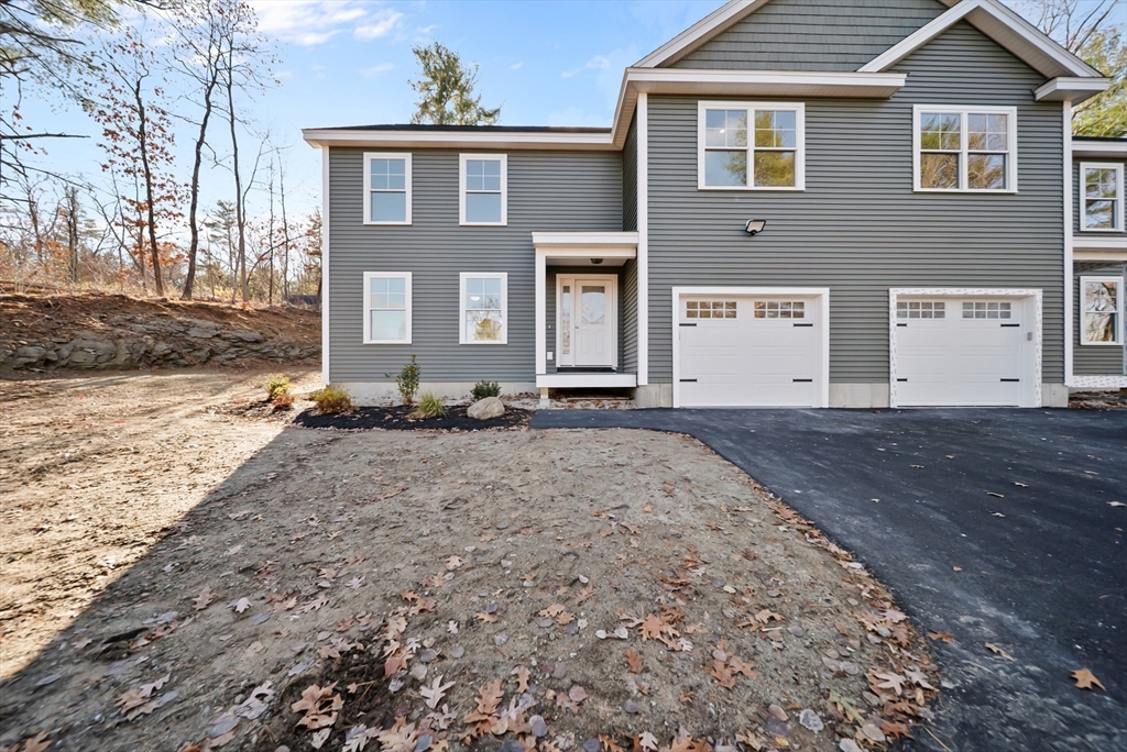 53 Kimball Hill Road, Unit A Hudson, NH 03051 - Photo 4 of 41 a front view of a house with a yard