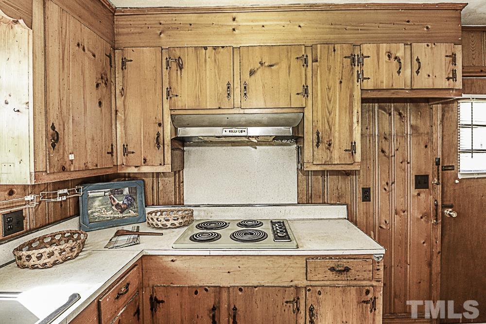 2508 Highway 42 Macclesfield, NC 27852 - Photo 17 of 24 a kitchen with granite countertop a stove and a refrigerator
