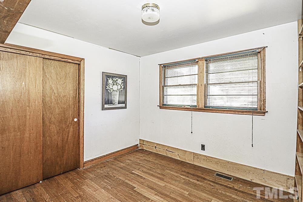2508 Highway 42 Macclesfield, NC 27852 - Photo 20 of 24 a view of an empty room with wooden floor and a window
