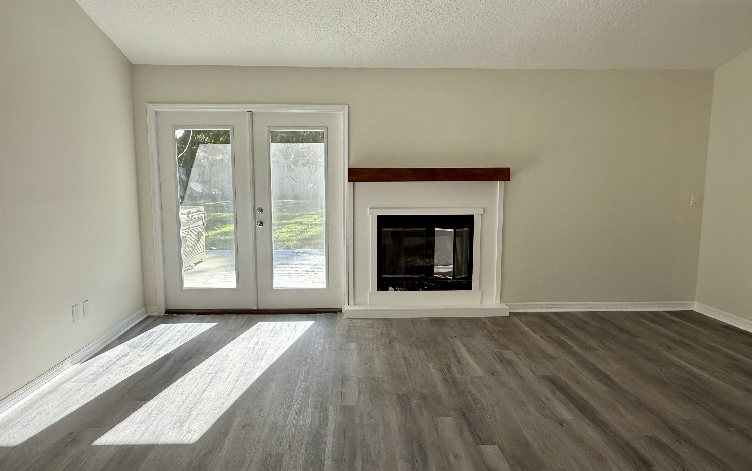 3508 Kings Road South St. Augustine, FL 32086 - Photo 11 of 32 a view of an empty room with wooden floor fireplace and a window