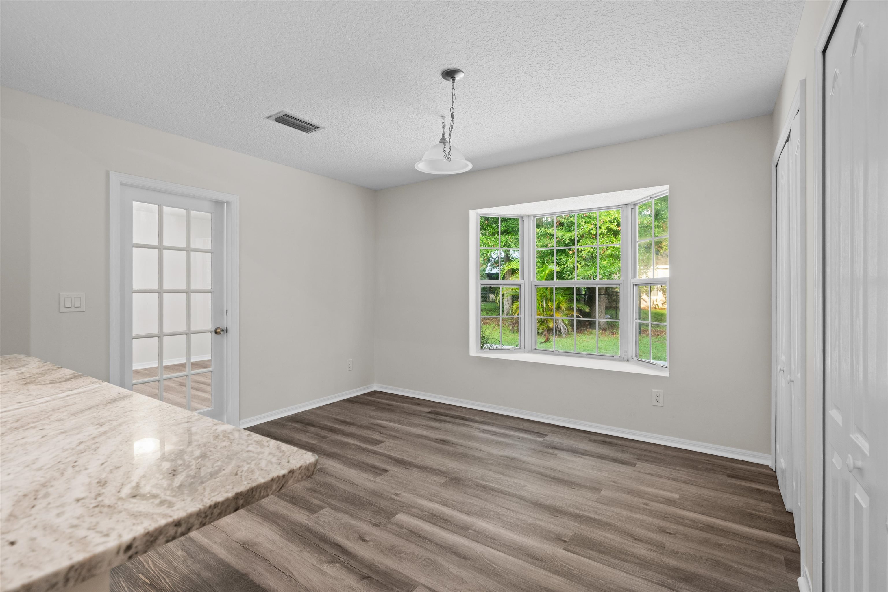 3508 Kings Road South St. Augustine, FL 32086 - Photo 20 of 32 an empty room with wooden floor and windows