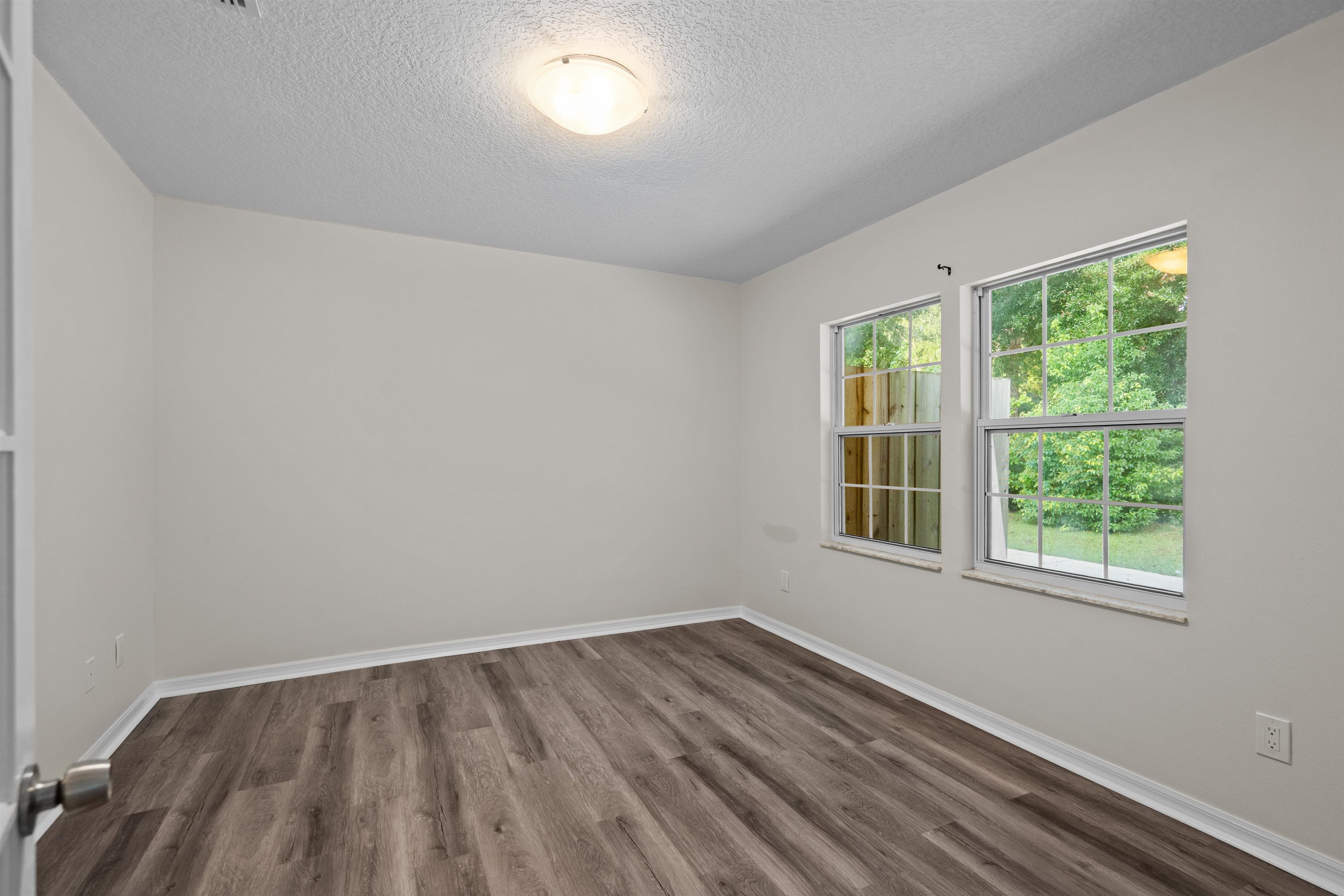 3508 Kings Road South St. Augustine, FL 32086 - Photo 21 of 32 an empty room with wooden floor and windows