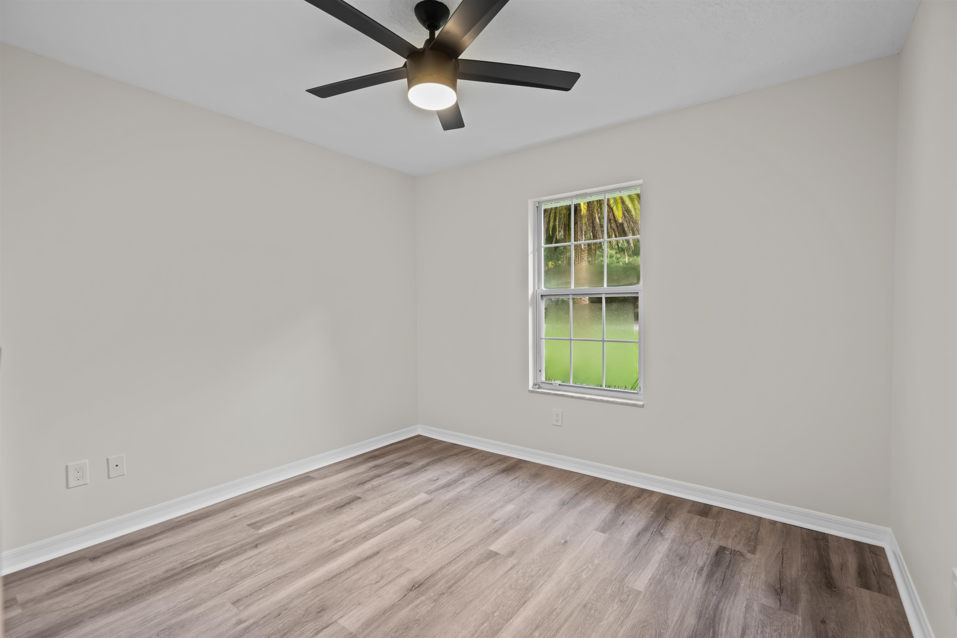 3508 Kings Road South St. Augustine, FL 32086 - Photo 24 of 32 an empty room with a window and a fan