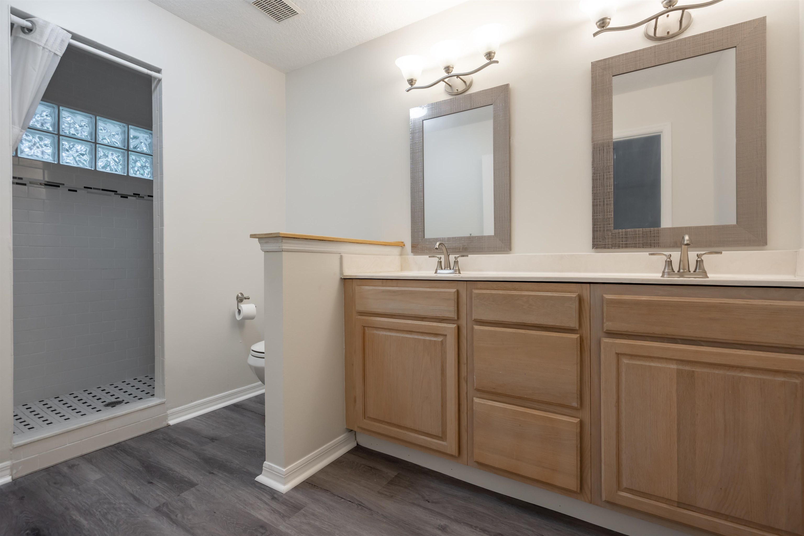 3508 Kings Road South St. Augustine, FL 32086 - Photo 31 of 32 a bathroom with a double vanity sink and mirror