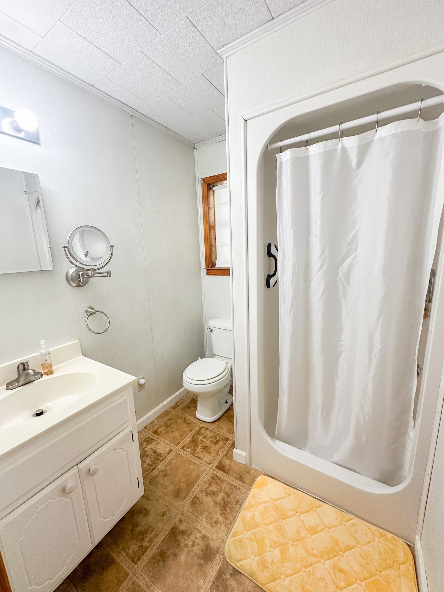 1630 Pleasant Hill Road Iuka, MS 38852 - Photo 11 of 14 a bathroom with a sink toilet and shower