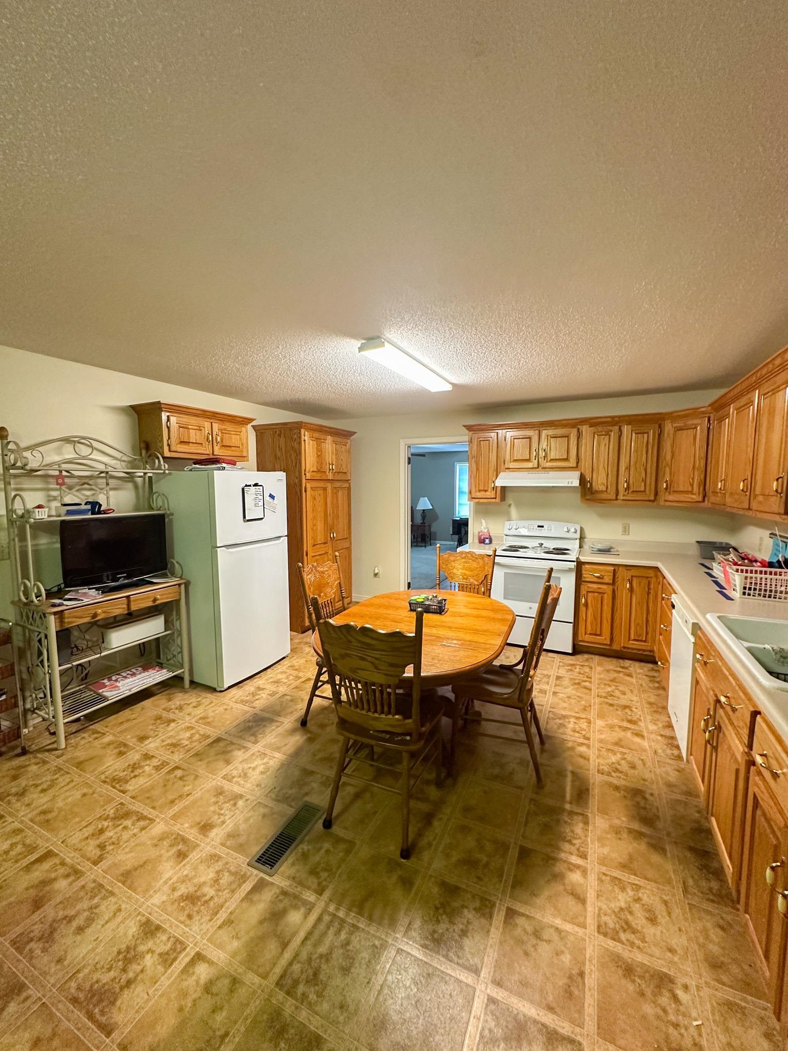 1630 Pleasant Hill Road Iuka, MS 38852 - Photo 6 of 14 a living room with furniture a flat screen tv and a refrigerator