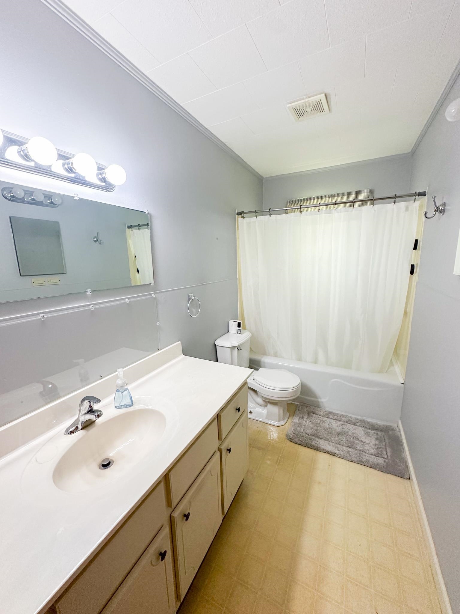 1630 Pleasant Hill Road Iuka, MS 38852 - Photo 9 of 14 a bathroom with a granite countertop sink and a mirror