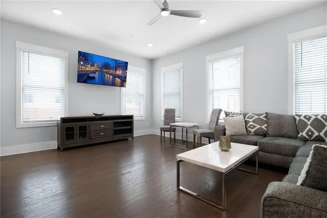 a living room with furniture and wooden floor