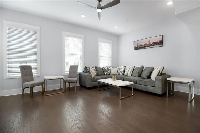 a living room with furniture and a wooden floor