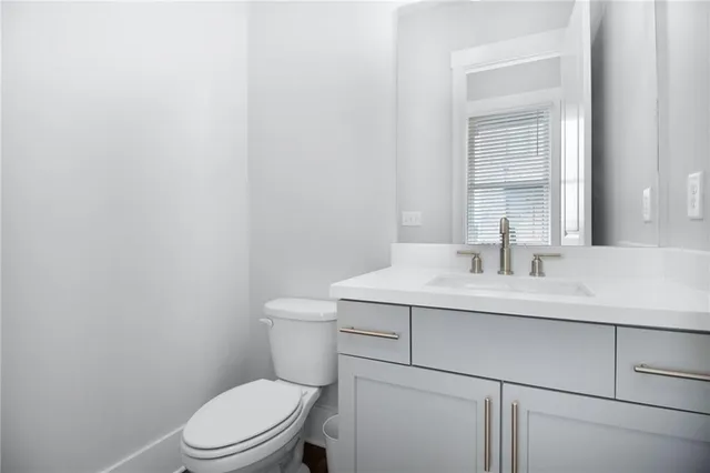 a bathroom with a sink a toilet and mirror