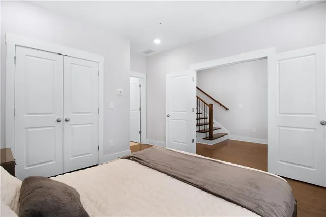 a bedroom with a bed and a painting on the wall