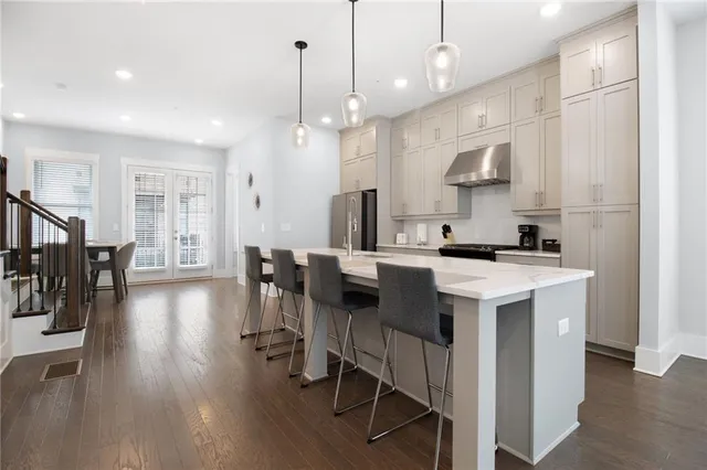 a kitchen with stainless steel appliances kitchen island a island in the center and wooden floors