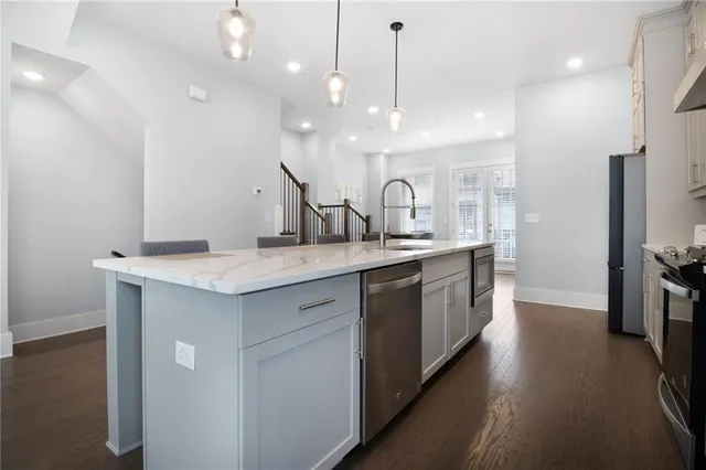 a kitchen with a sink a counter space and stainless steel appliances
