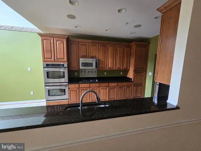 a kitchen with a refrigerator stove and microwave