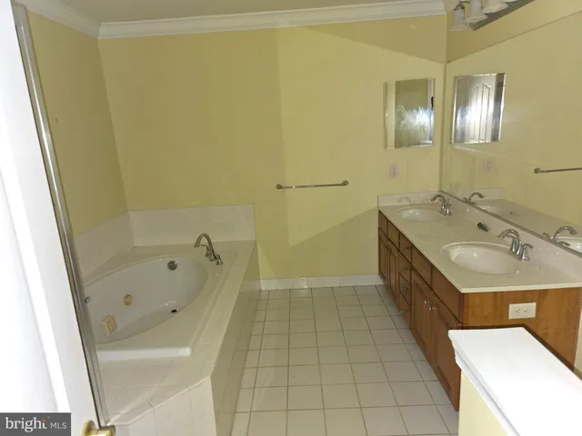 a bathroom with a tub sink and mirror