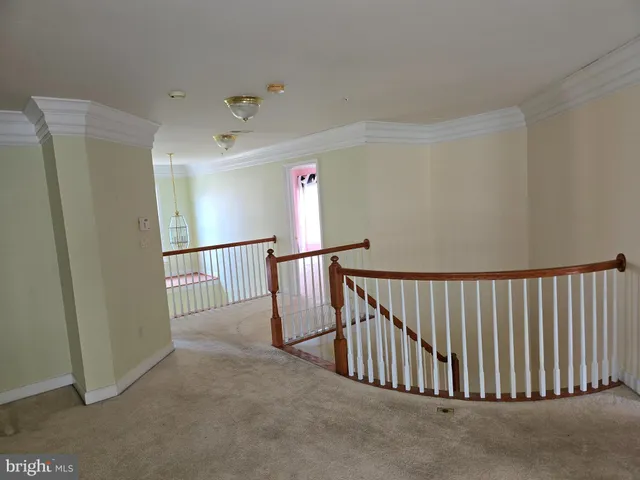 a view of an empty room with stairs