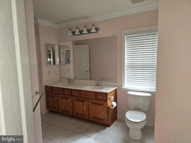 a bedroom with a bed and painting on the wall