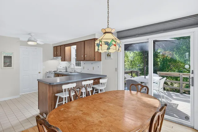 a living room with furniture ceiling fan and a rug