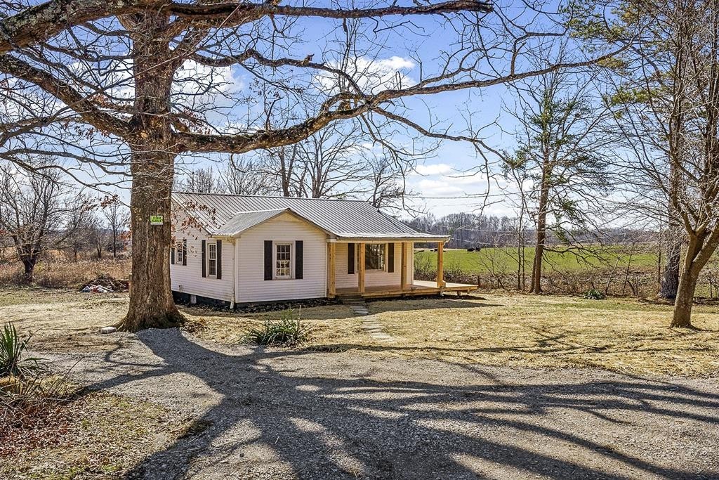a view of a house with a yard covered in snow