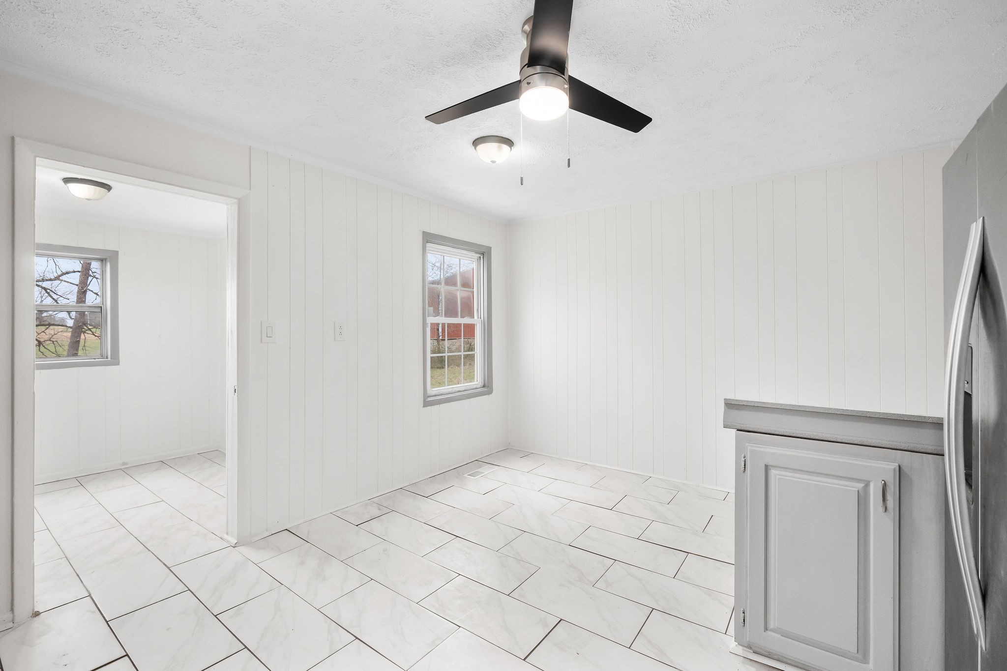 8626 Bockman Way Sparta, TN 38583 - Photo 11 of 25 an empty room with windows and fan