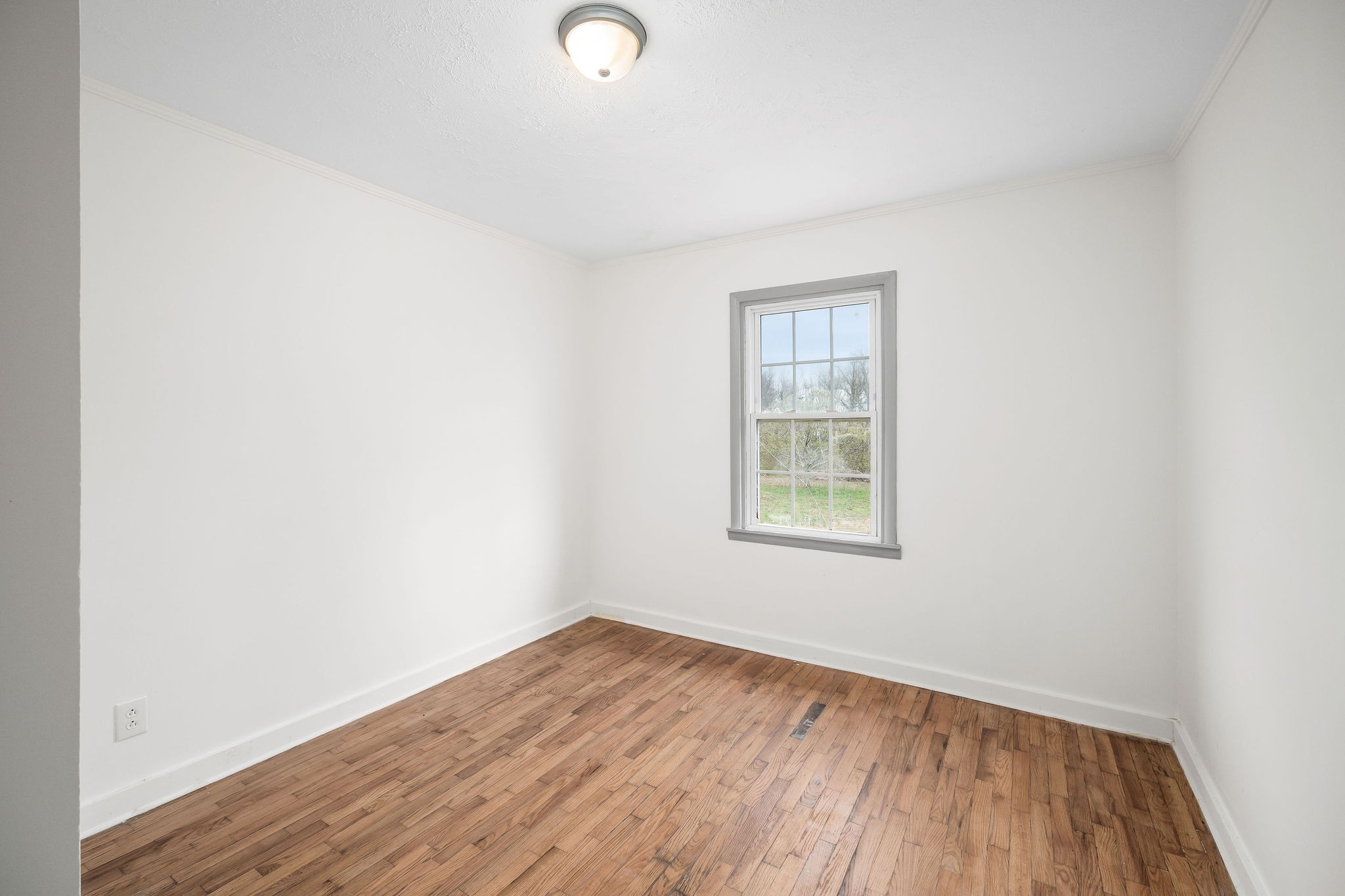 8626 Bockman Way Sparta, TN 38583 - Photo 13 of 25 an empty room with wooden floor and windows