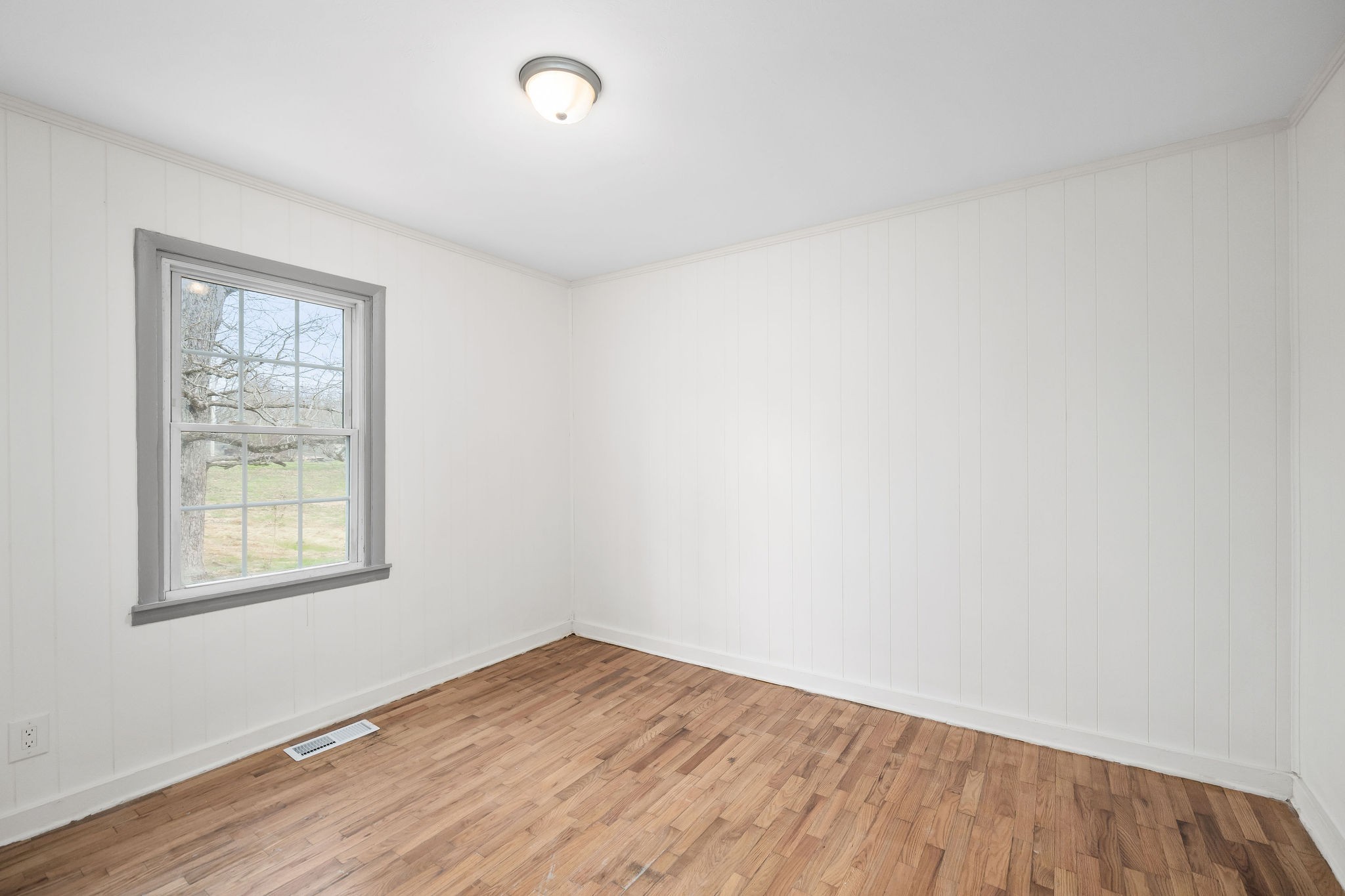 8626 Bockman Way Sparta, TN 38583 - Photo 15 of 25 an empty room with wooden floor and windows