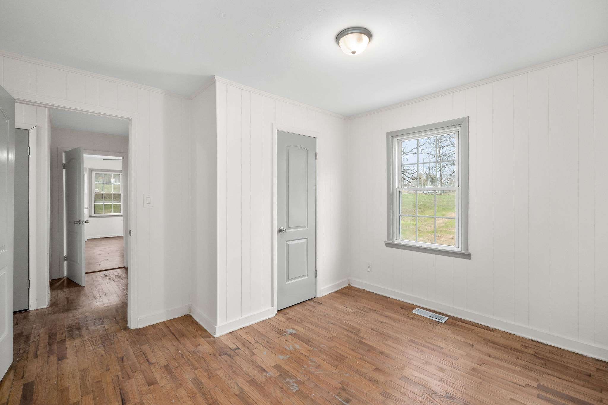 8626 Bockman Way Sparta, TN 38583 - Photo 16 of 25 an empty room with wooden floor and a window