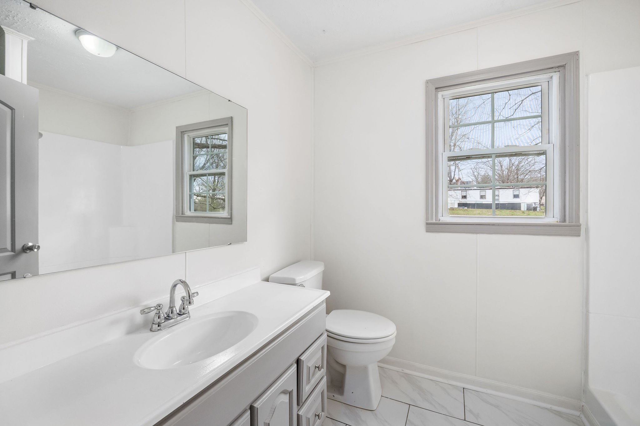8626 Bockman Way Sparta, TN 38583 - Photo 17 of 25 a bathroom with a sink toilet and a mirror