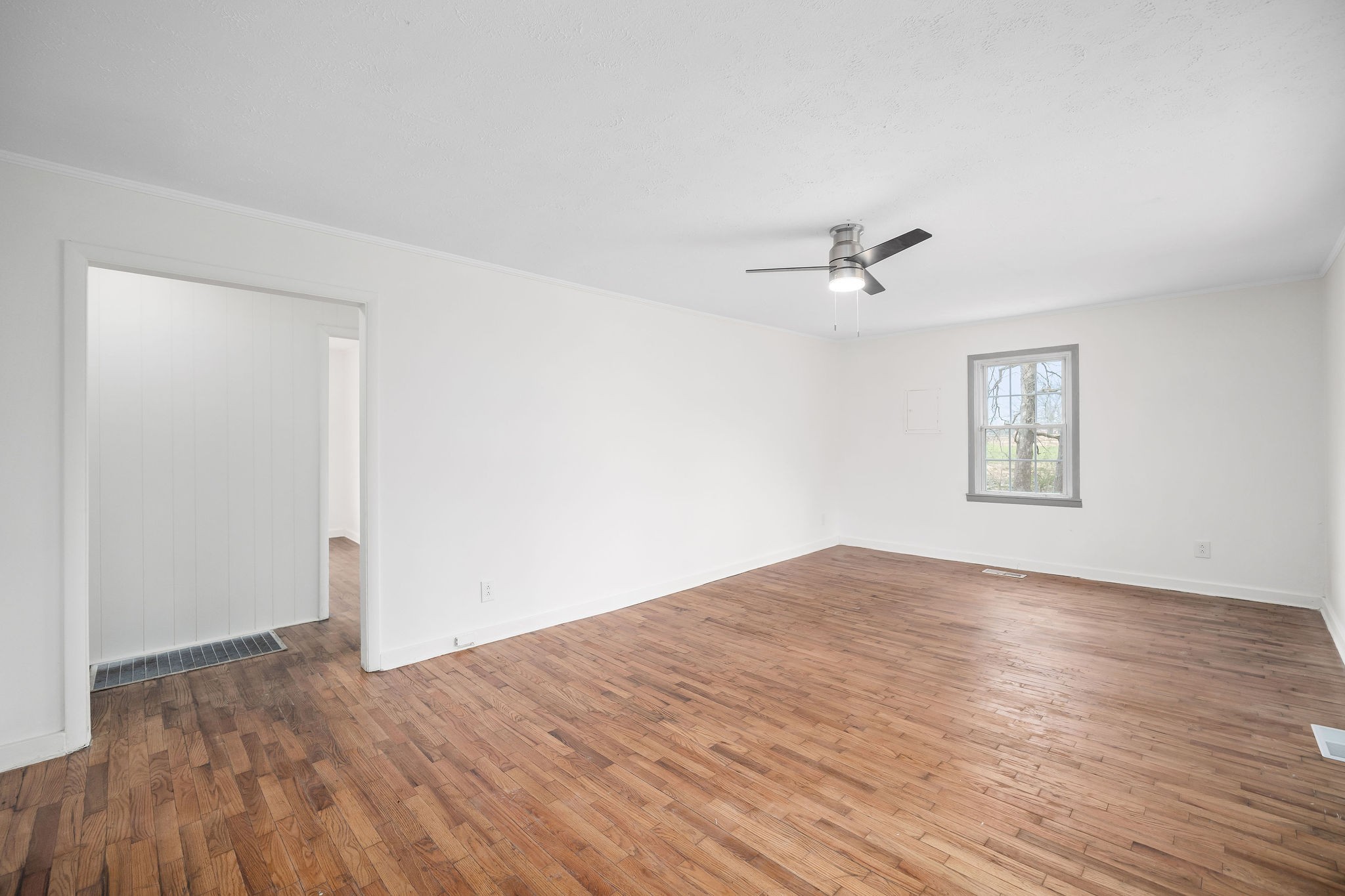 8626 Bockman Way Sparta, TN 38583 - Photo 5 of 25 an empty room with wooden floor and windows