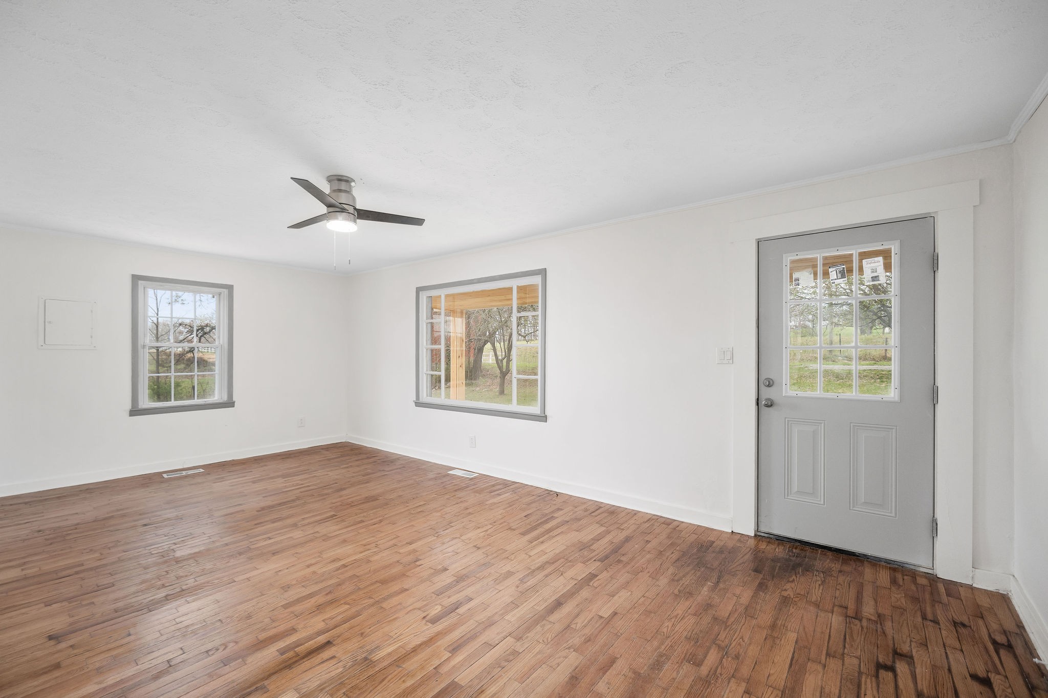 8626 Bockman Way Sparta, TN 38583 - Photo 6 of 25 a view of an empty room with a window and wooden floor