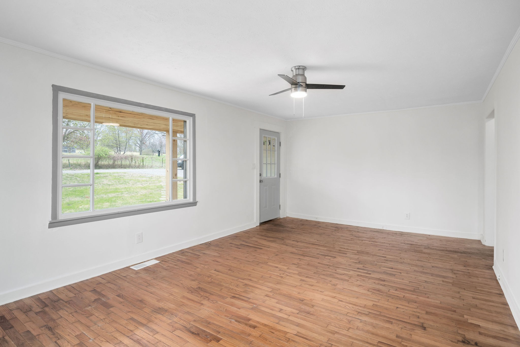 8626 Bockman Way Sparta, TN 38583 - Photo 7 of 25 a view of empty room with wooden floor and fan