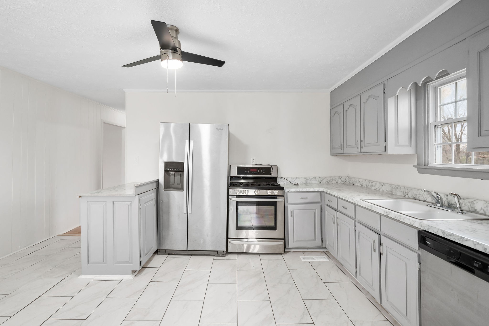 8626 Bockman Way Sparta, TN 38583 - Photo 10 of 25 a kitchen with white cabinets and stainless steel appliances