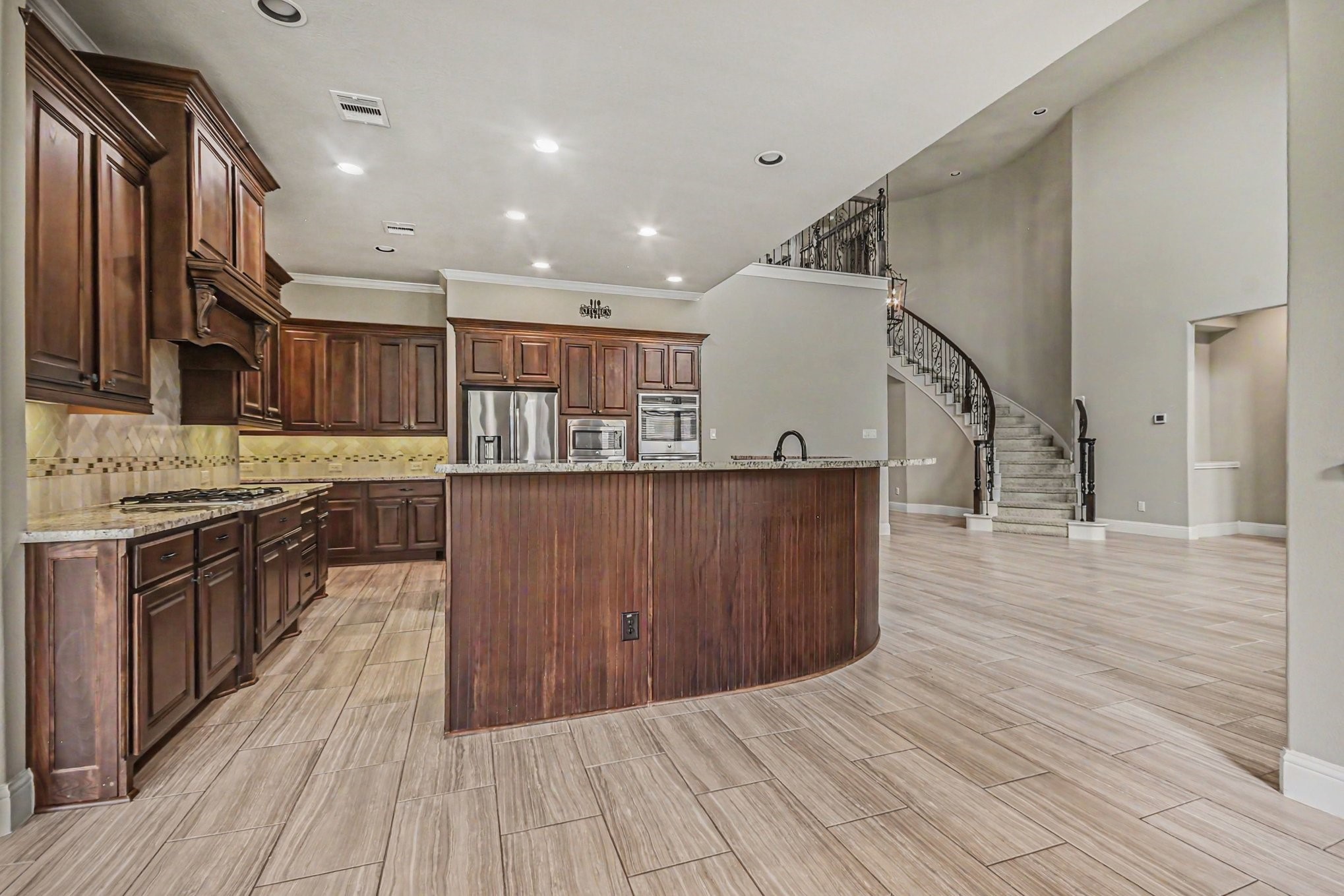 3310 Ralston Edge Lane Houston, TX 77059 - Photo 20 of 50 a kitchen with wooden floors and a sink