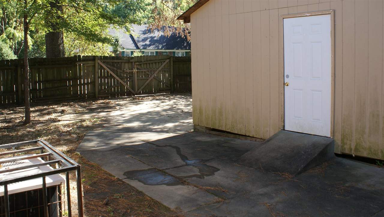 6205 Ridge Manor Drive Memphis, TN 38115 - Photo 5 of 8 a view of backyard with wooden fence