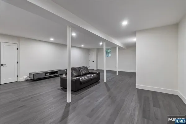 a view of a room with wooden floor and window