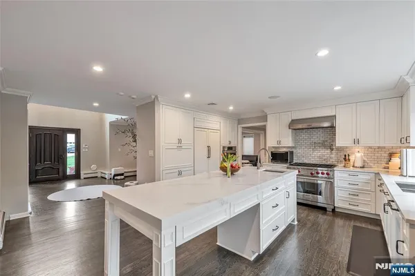 a large kitchen with stainless steel appliances lots of counter top space
