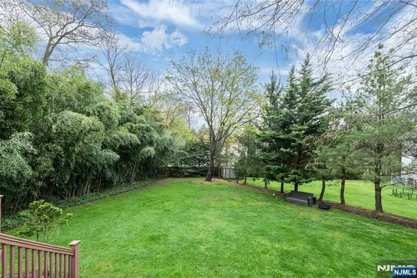 a view of green field with trees in the background