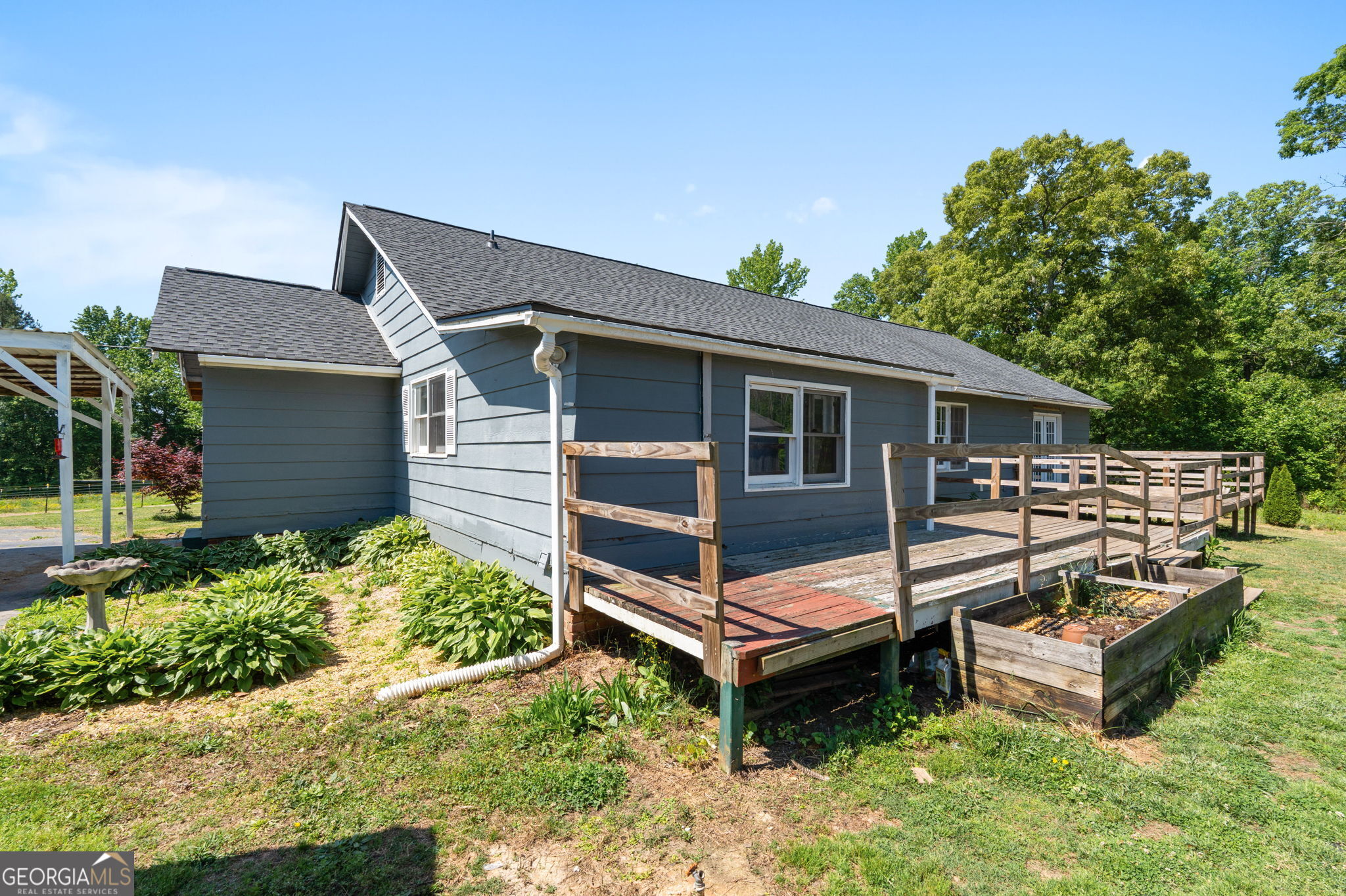 49 Frost Road Bowdon, GA 30108 - Photo 36 of 60 a wooden bench sitting in backyard of a house