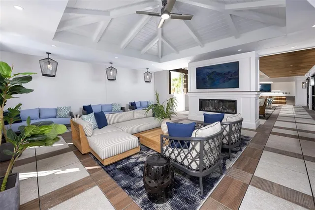 a living room with furniture and a potted plant
