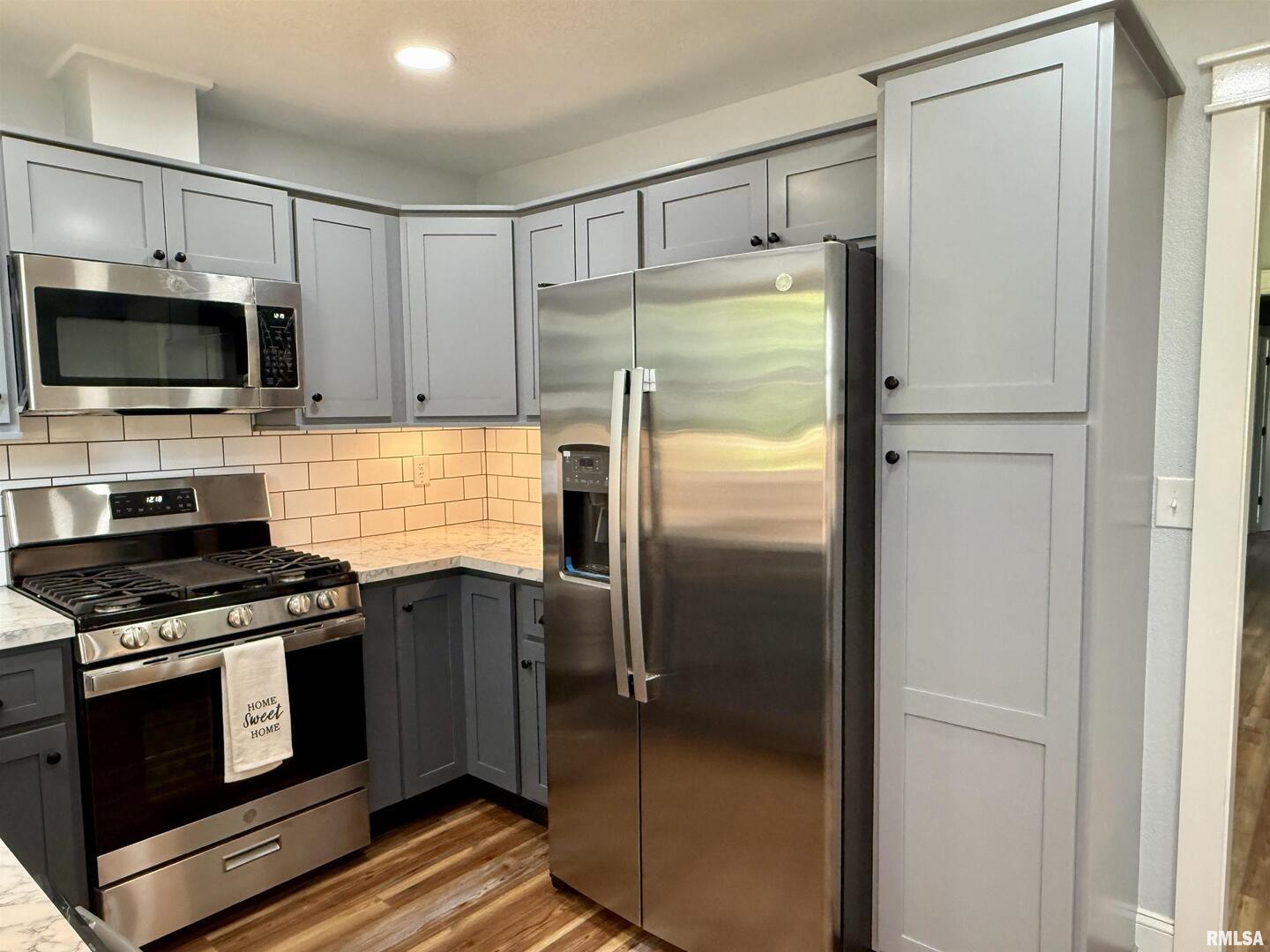 744 Airport Road Metropolis, IL 62960 - Photo 11 of 33 a kitchen with stainless steel appliances granite countertop a refrigerator and a stove top oven