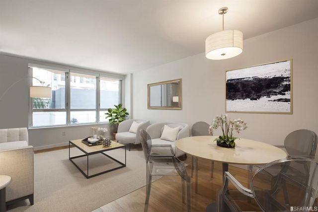a living room with furniture a chandelier and a flat screen tv
