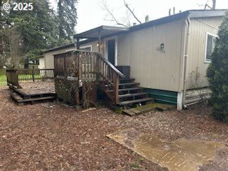 a view of a house with backyard and wooden fence