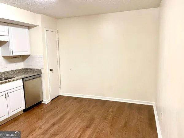 a view of a kitchen with wooden floor and a sink