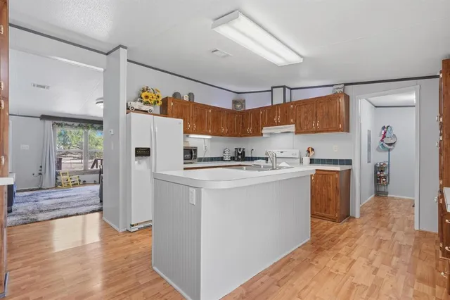 a kitchen that has a sink and a table in it