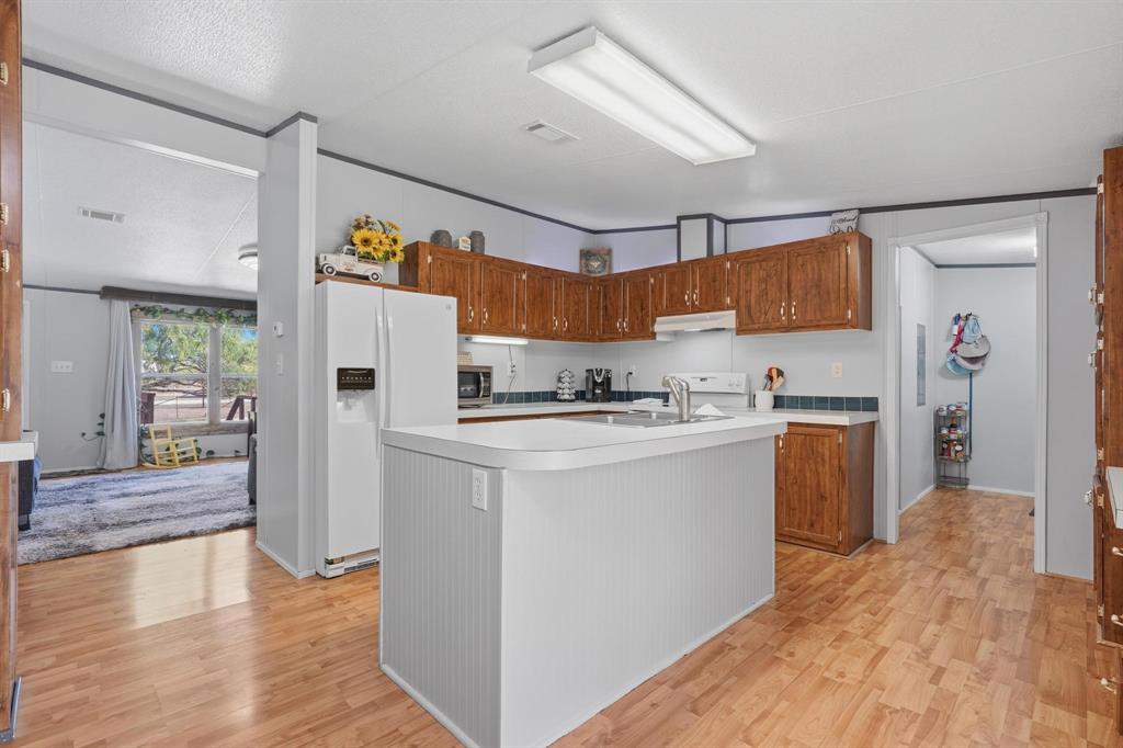 20082 County Road 304 Abilene, TX 79601 - Photo 12 of 36 a kitchen with a refrigerator and a sink