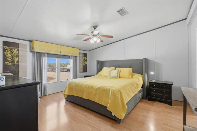 a bathroom with a granite countertop sink a mirror and shower