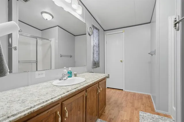 a bathroom with a glass shower door