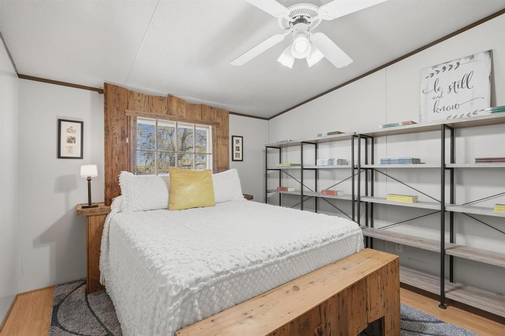 20082 County Road 304 Abilene, TX 79601 - Photo 22 of 36 a bedroom with a large bed and a chandelier
